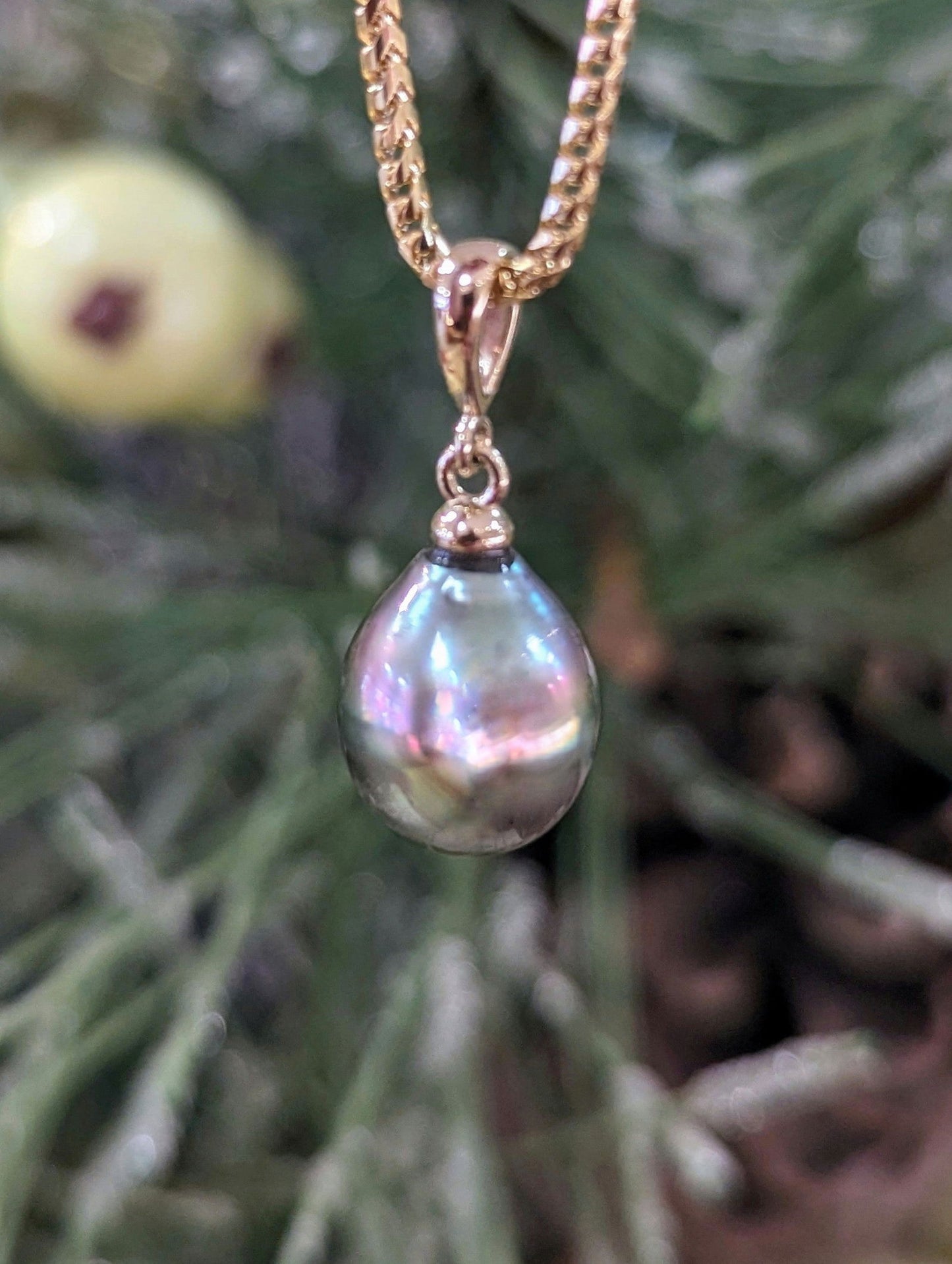 Photo of Tahitian Pearl Drop Pendant in a decorative scene, designed by , available at Plumb Gold & Plumb Silver