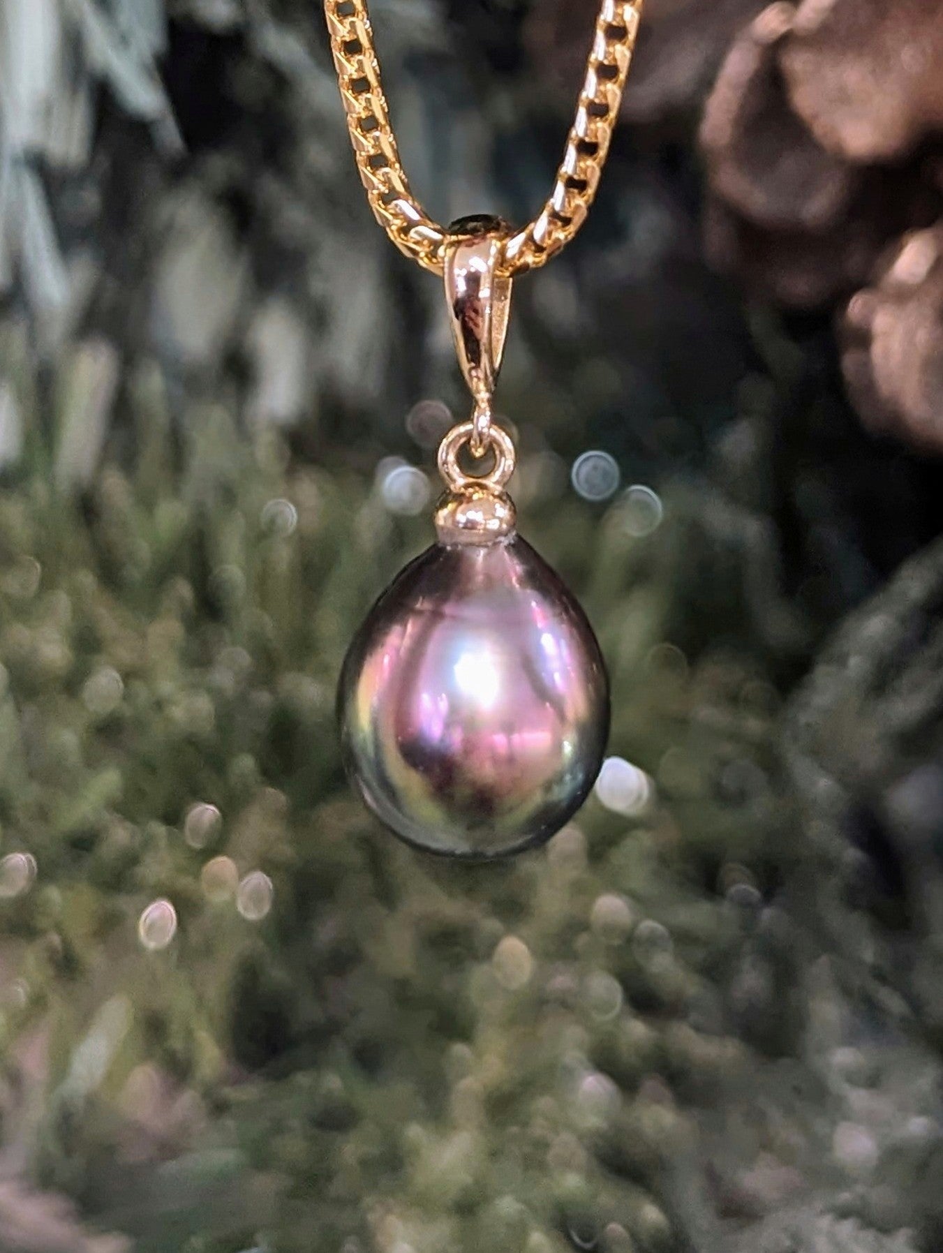 Photo of Tahitian Pearl Drop Pendant in a decorative scene, designed by , available at Plumb Gold & Plumb Silver