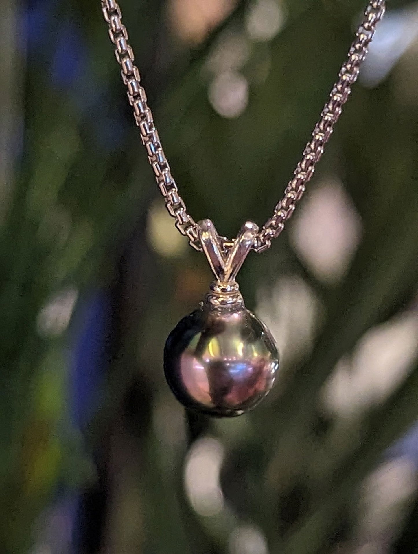 Photo of Tahitian Pearl Pendant in a decorative scene, designed by , available at Plumb Gold & Plumb Silver