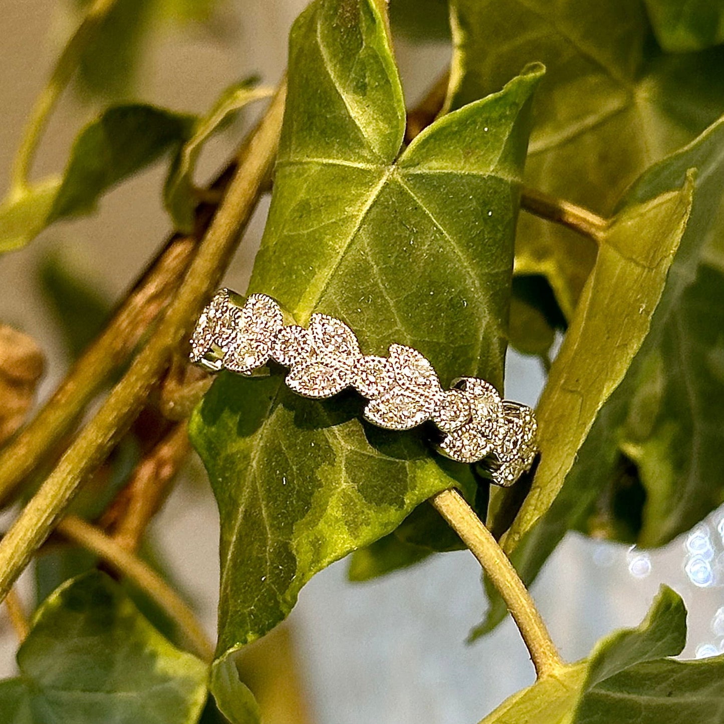 Photo of The "Erica" Band in a decorative scene, designed by , available at Plumb Gold & Plumb Silver