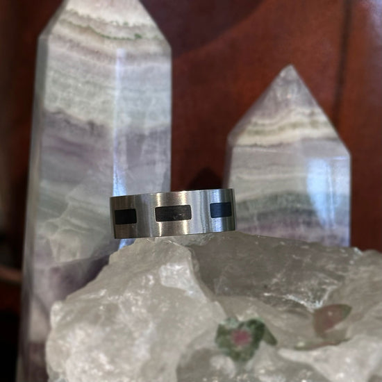 Photo of Titanium Black Accent Band in a decorative scene, designed by , available at Plumb Gold & Plumb Silver