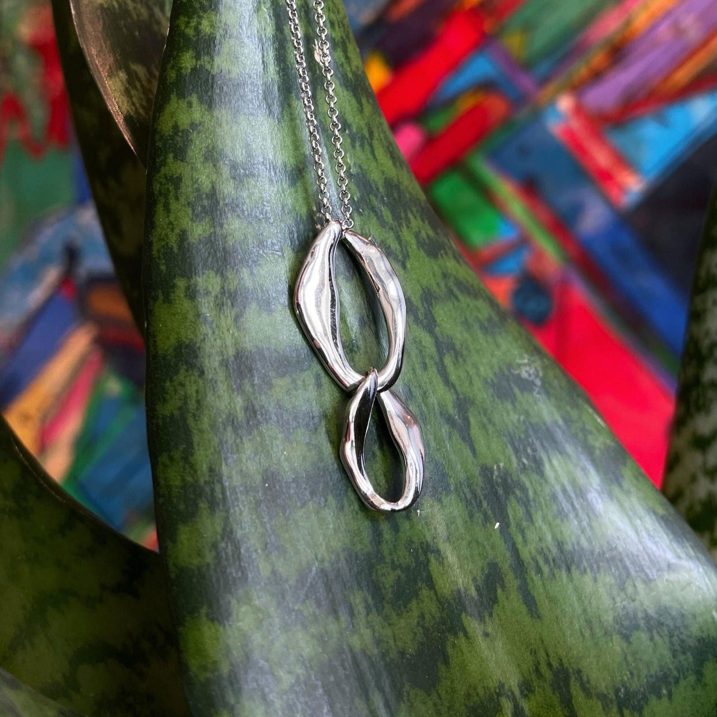 Photo of "Together" Pendant in a decorative scene, designed by , available at Plumb Gold & Plumb Silver