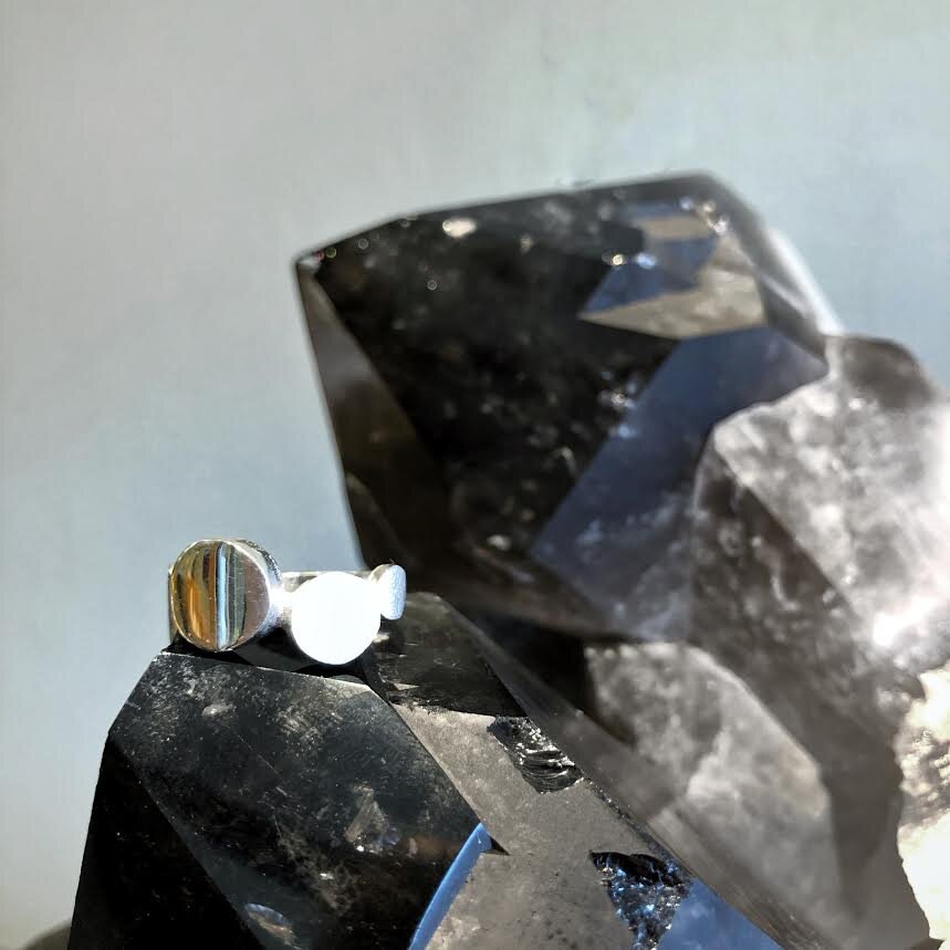 Photo of Traveling Dots Ring in a decorative scene, designed by , available at Plumb Gold & Plumb Silver