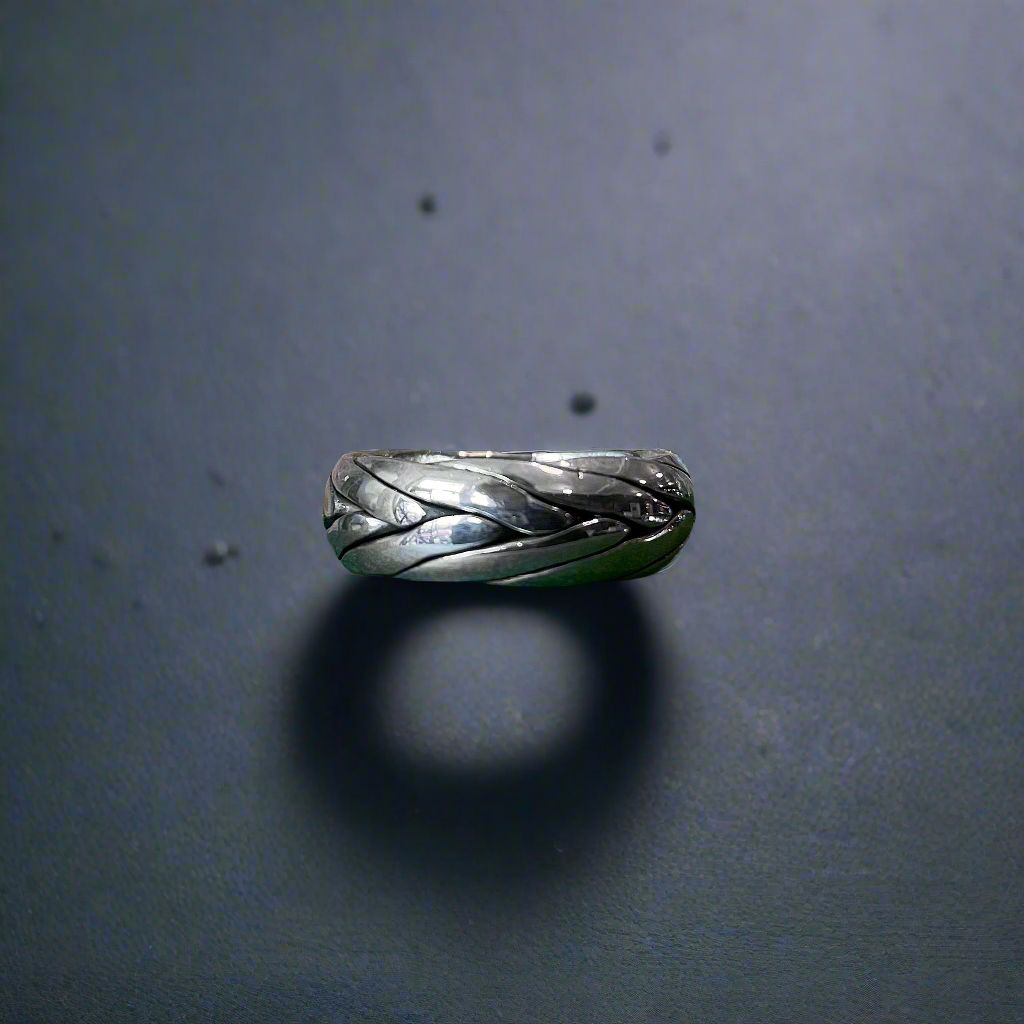 Photo of “Tribal” Ring in a decorative scene, designed by , available at Plumb Gold & Plumb Silver