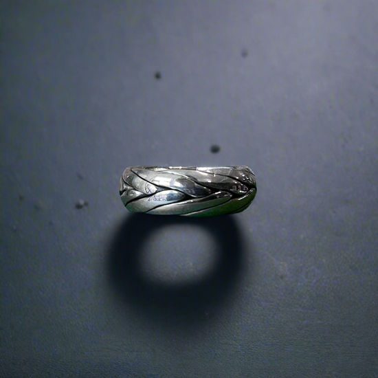 Photo of “Tribal” Ring in a decorative scene, designed by , available at Plumb Gold & Plumb Silver