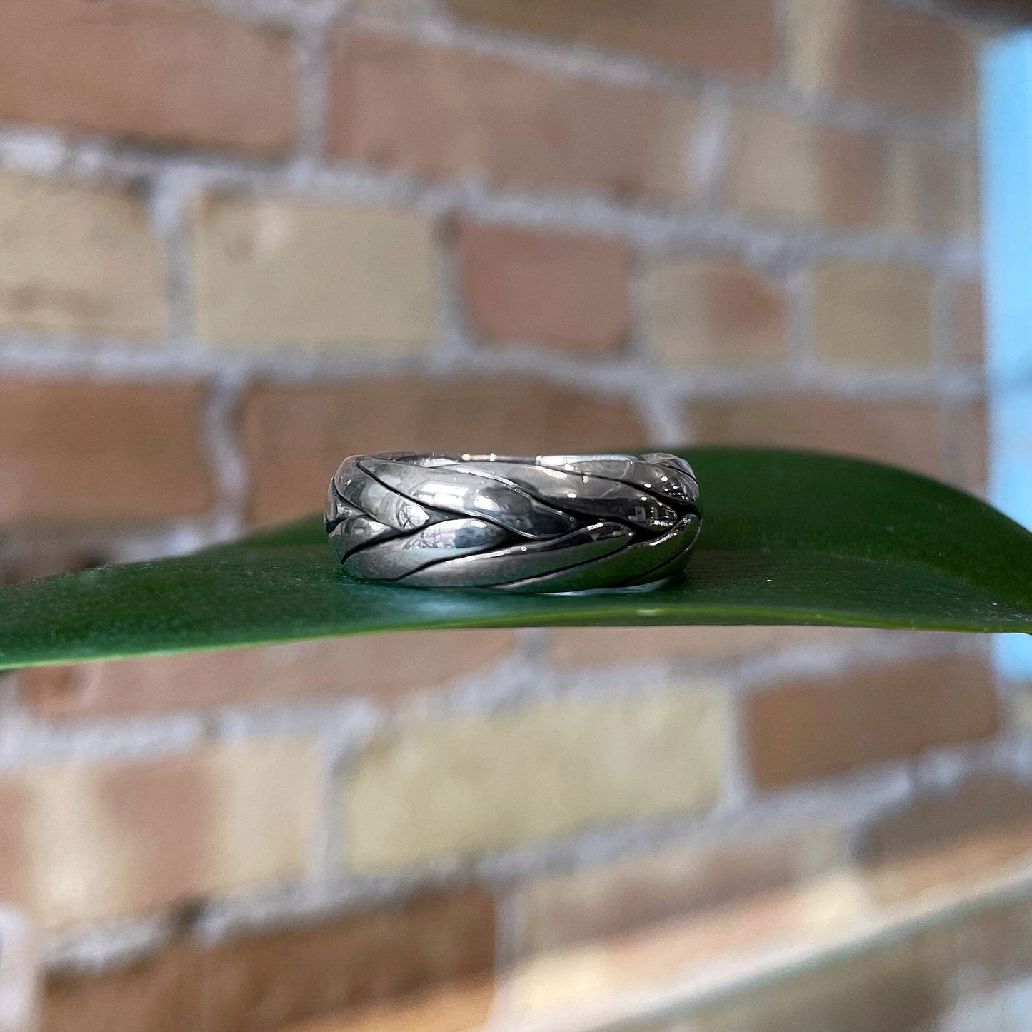 Photo of “Tribal” Ring in a decorative scene, designed by , available at Plumb Gold & Plumb Silver