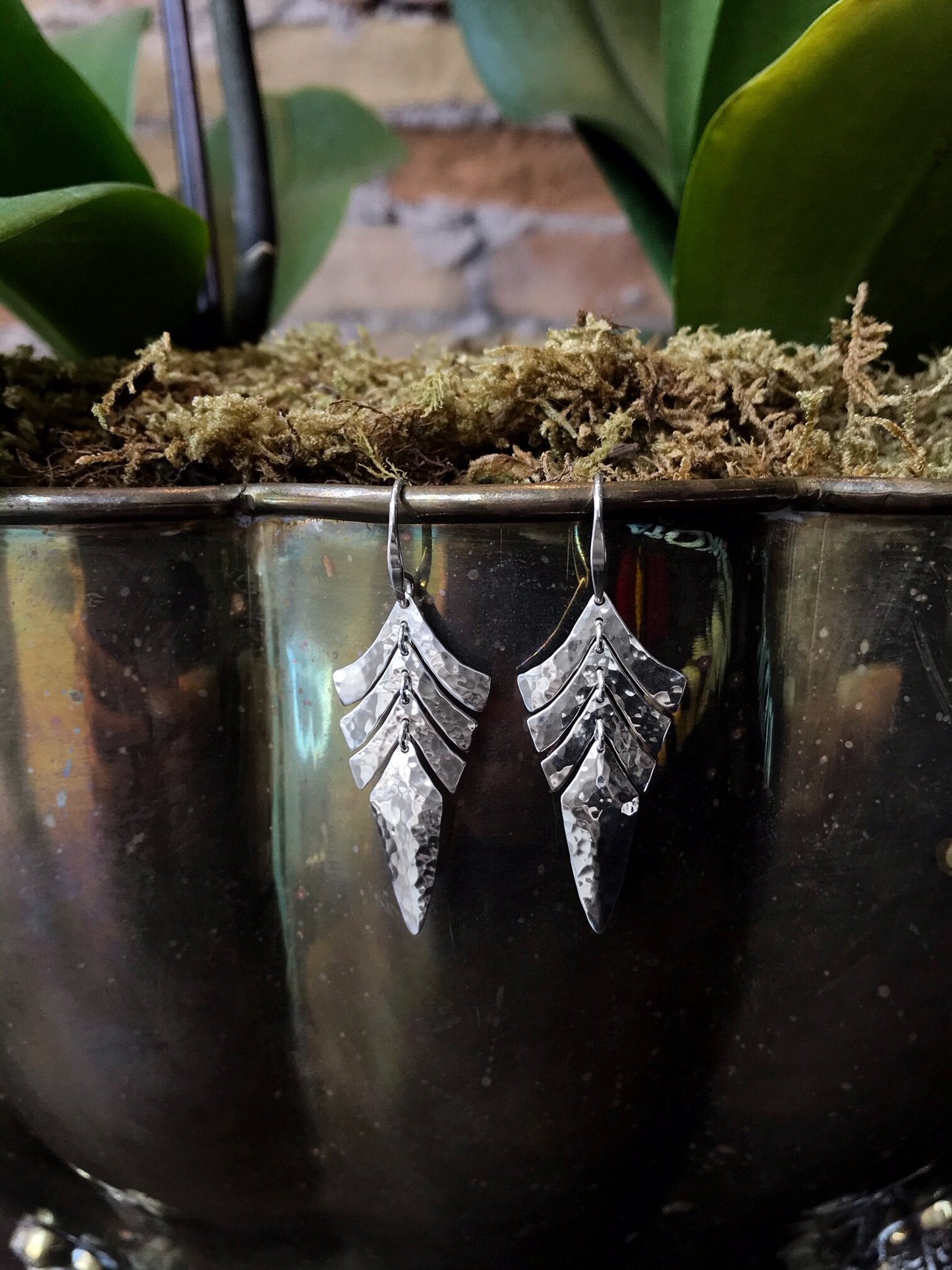 Photo of "Tropic" Earrings in a decorative scene, designed by , available at Plumb Gold & Plumb Silver