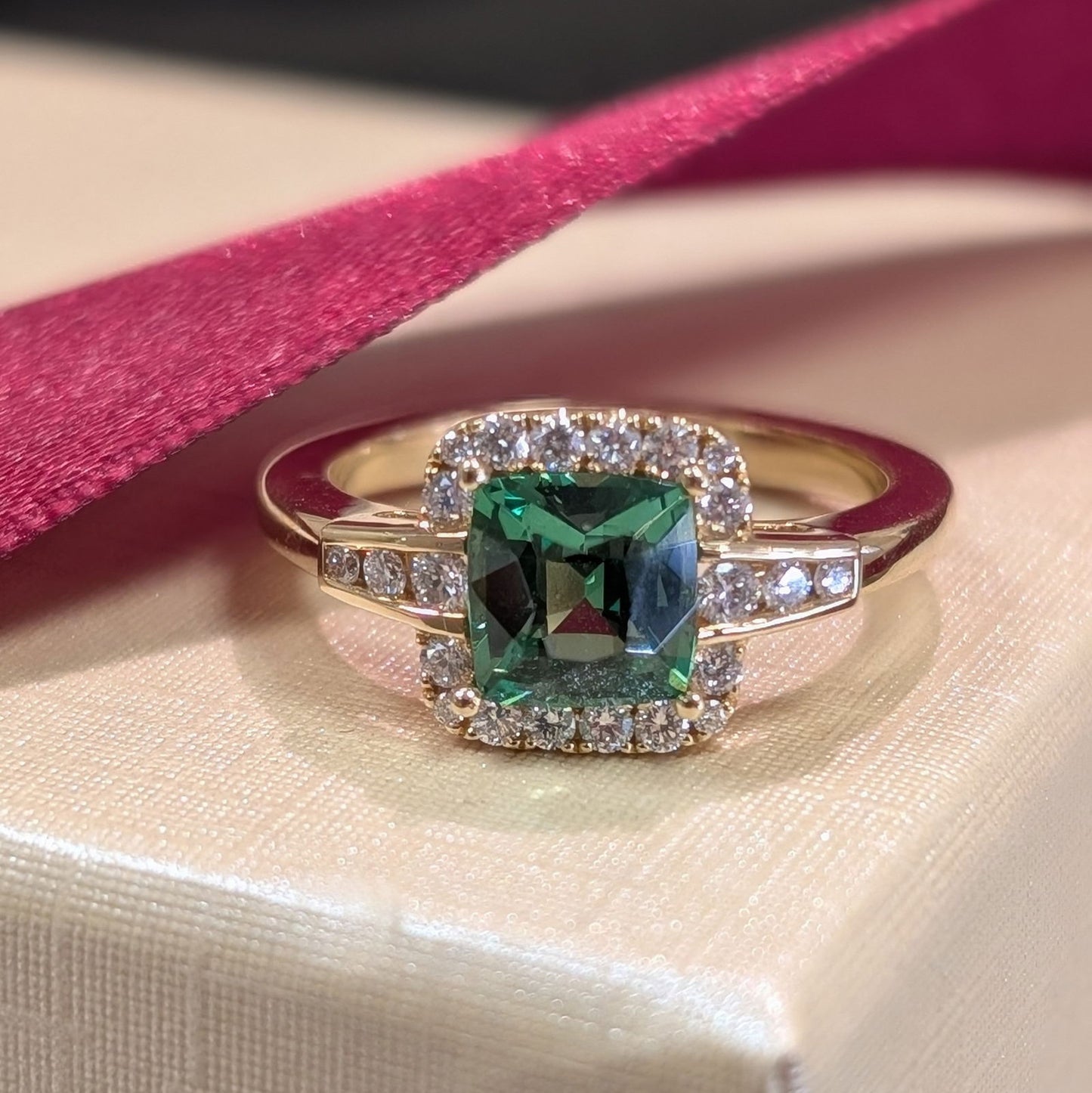 Photo of Tsavorite Halo Ring in a decorative scene, designed by , available at Plumb Gold & Plumb Silver