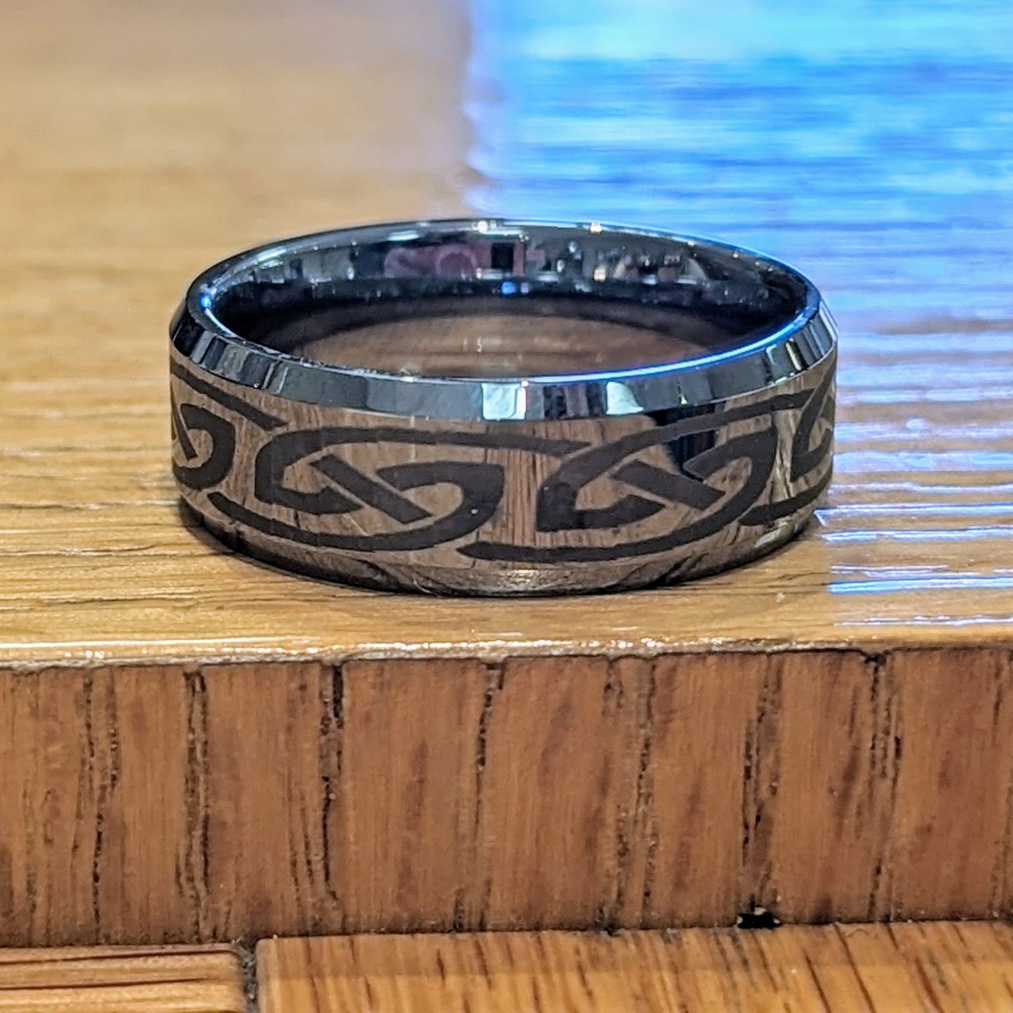 Photo of Tungsten Bevel Edge Band in a decorative scene, designed by , available at Plumb Gold & Plumb Silver
