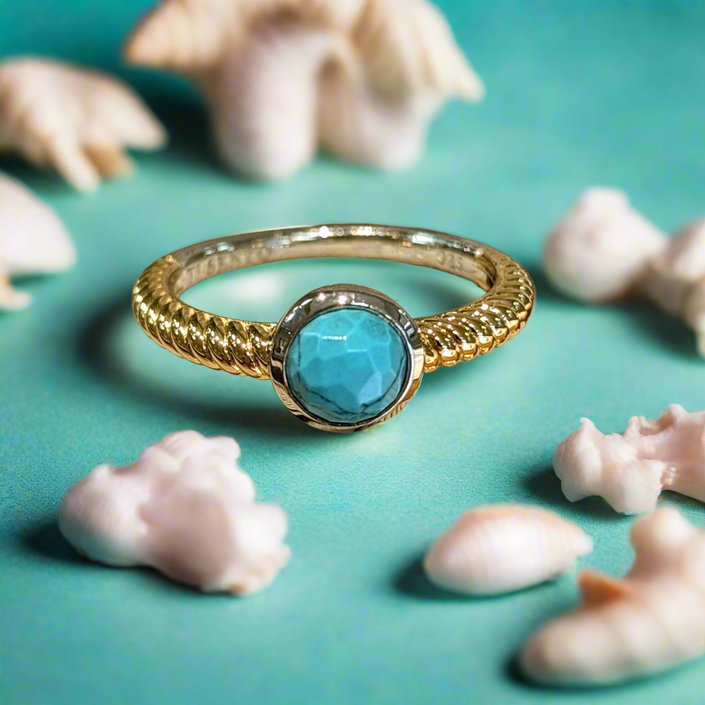 Photo of Turquoise Bezel Rope Ring in a decorative scene, designed by , available at Plumb Gold & Plumb Silver