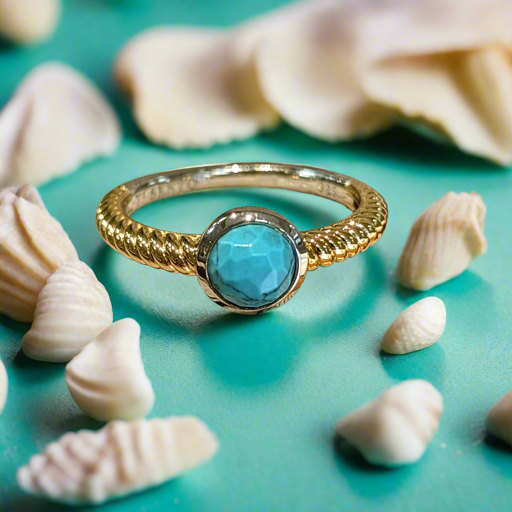 Photo of Turquoise Bezel Rope Ring in a decorative scene, designed by , available at Plumb Gold & Plumb Silver