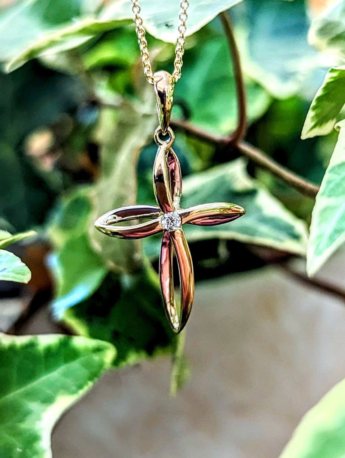 Photo of Twist Diamond Accented Cross in a decorative scene, designed by , available at Plumb Gold & Plumb Silver