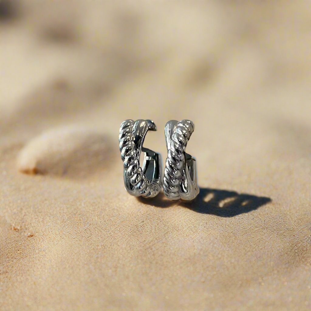 Photo of Twisted Rope Earrings in a decorative scene, designed by , available at Plumb Gold & Plumb Silver