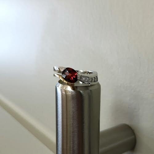 Photo of Two-Tone Red Garnet Ring in a decorative scene, designed by , available at Plumb Gold & Plumb Silver