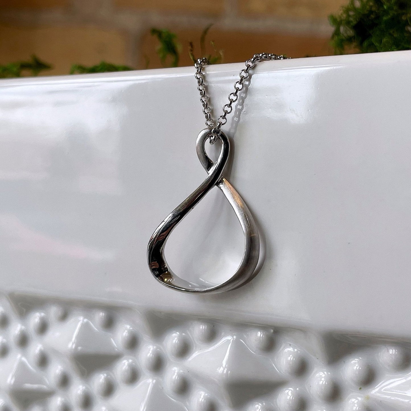 Photo of “Venice” Twist Pendant in a decorative scene, designed by , available at Plumb Gold & Plumb Silver