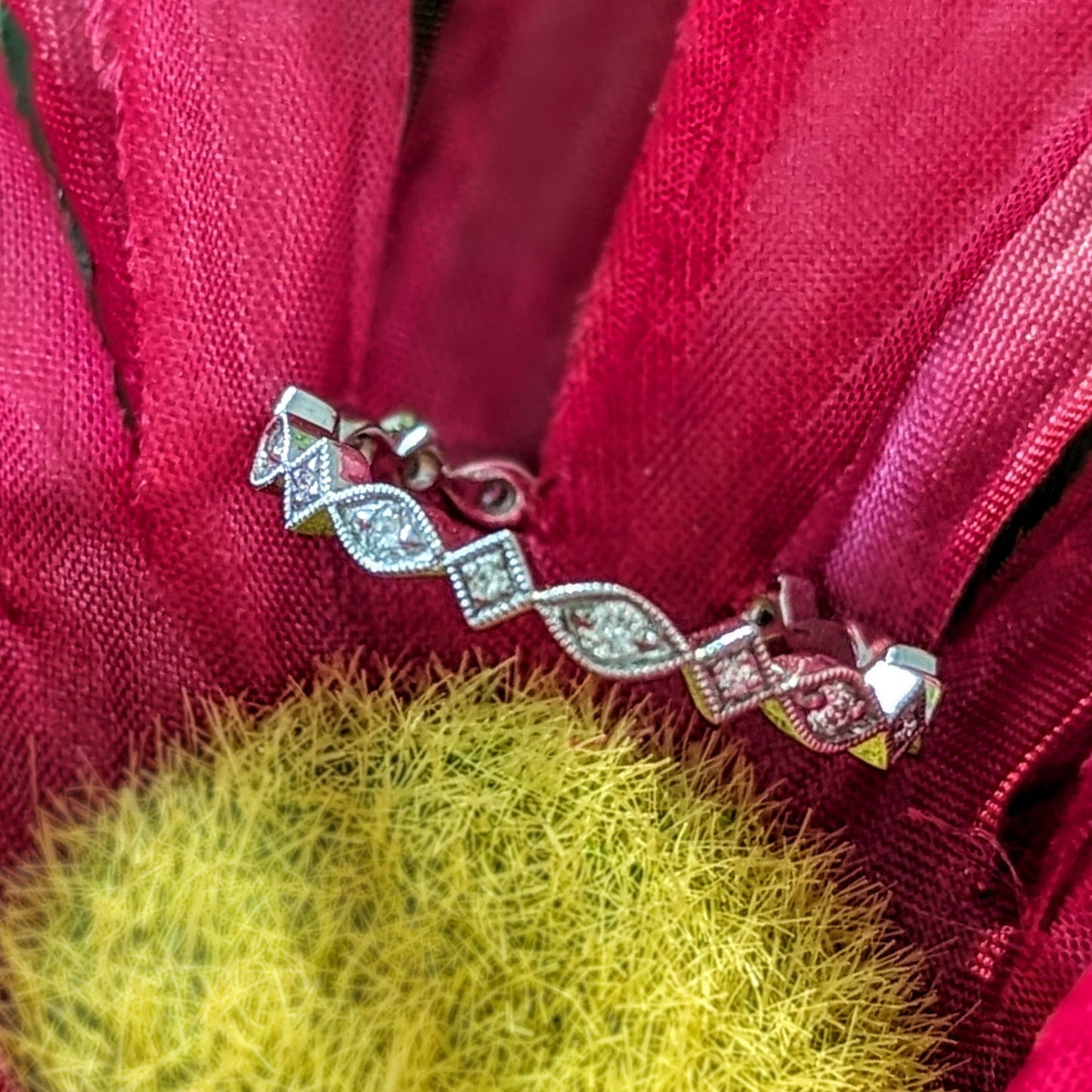 Photo of "Vera" Art Deco Band in a decorative scene, designed by , available at Plumb Gold & Plumb Silver