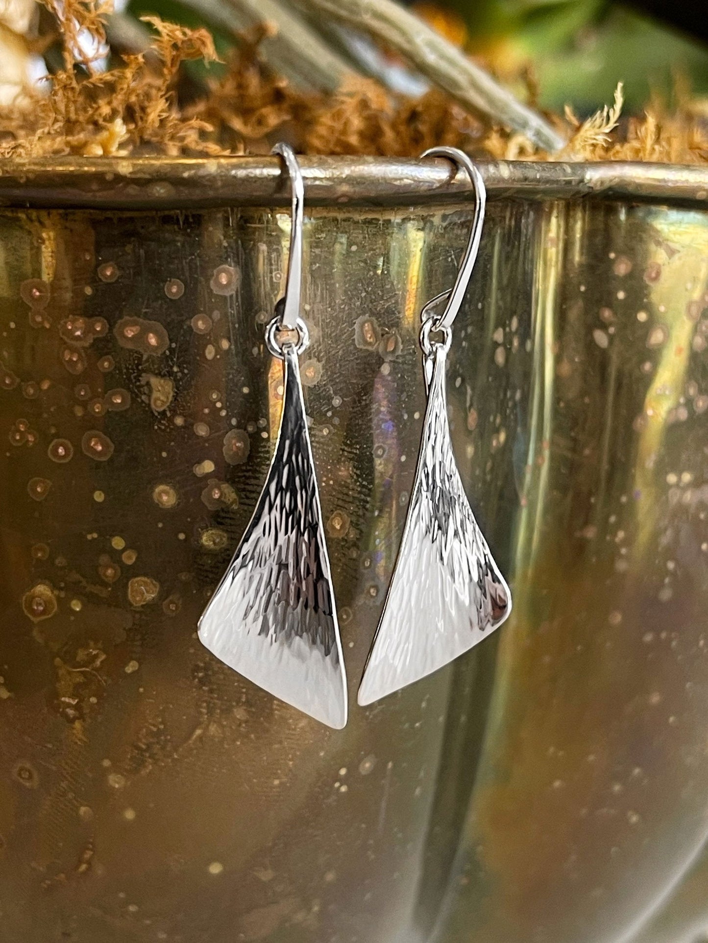 Photo of "Water" Earrings in a decorative scene, designed by , available at Plumb Gold & Plumb Silver