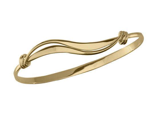 Photo of Wave Bracelet in a decorative scene, designed by , available at Plumb Gold & Plumb Silver