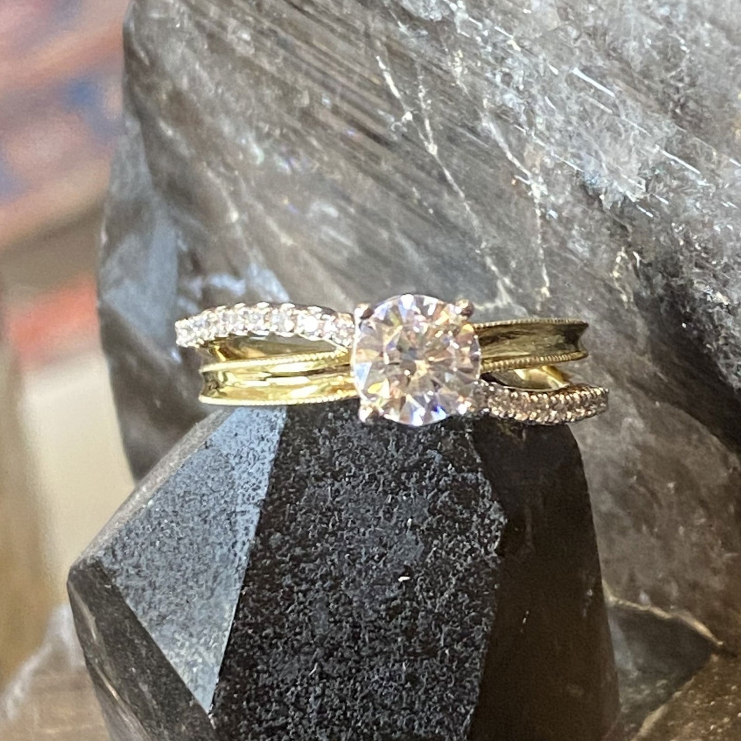 Photo of "Wave" Milgrain Concave Split Shank Engagement Ring in a decorative scene, designed by , available at Plumb Gold & Plumb Silver