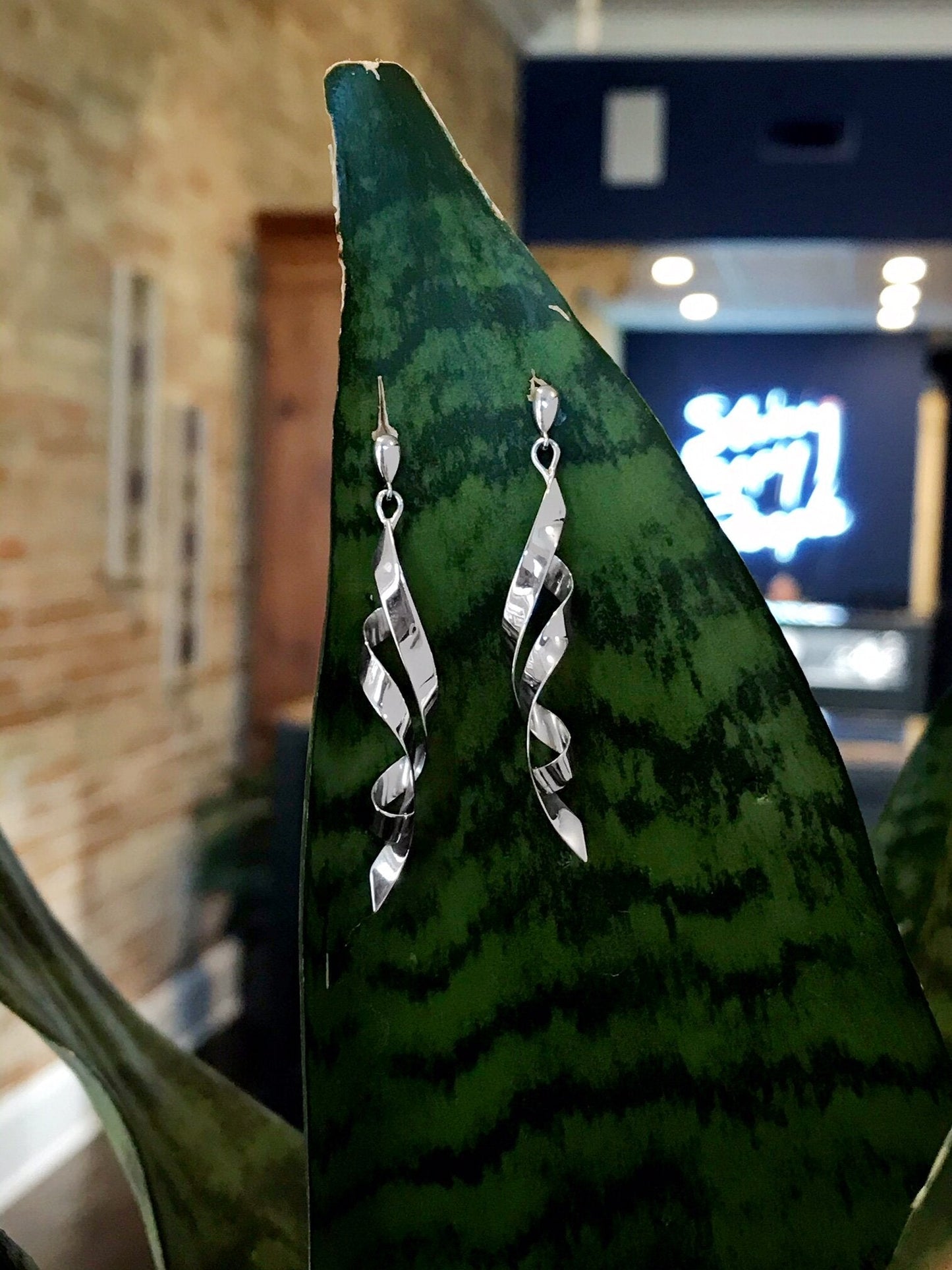 Photo of "Whirlwind" Dangles in a decorative scene, designed by , available at Plumb Gold & Plumb Silver