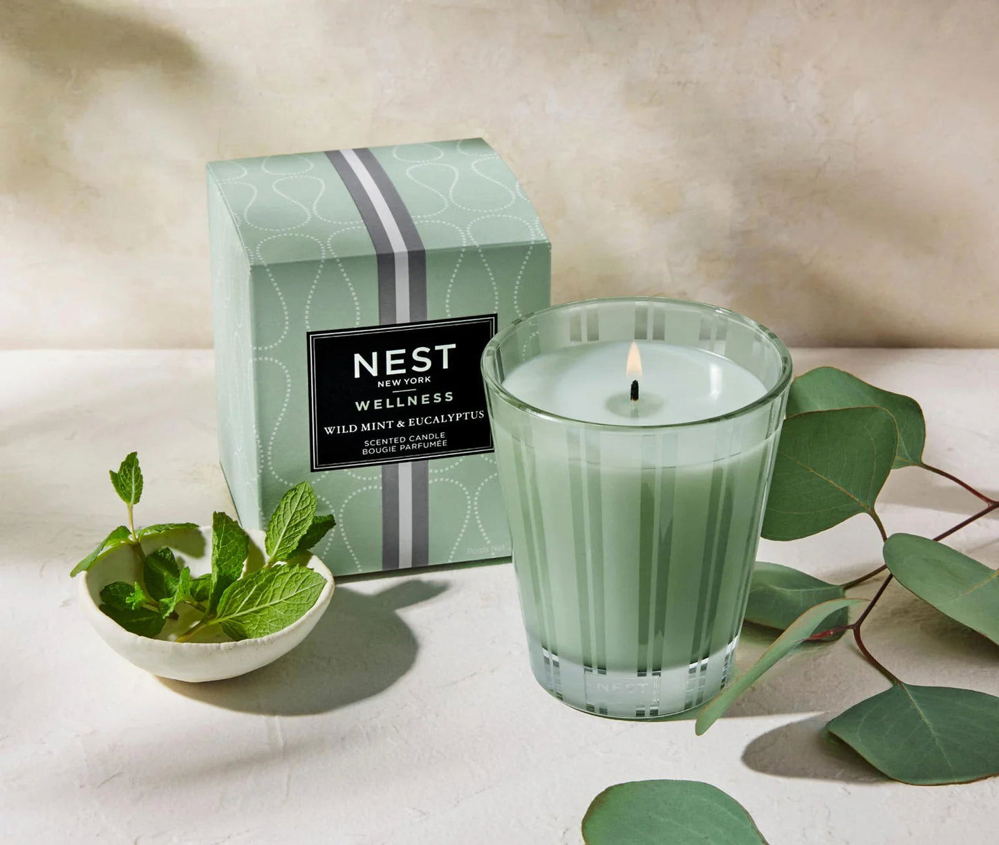 Photo of Wild Mint & Eucalyptus Candle in a decorative scene, designed by , available at Plumb Gold & Plumb Silver