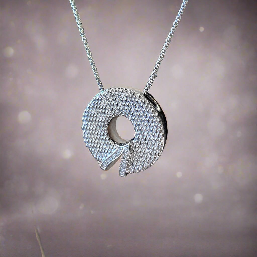 Photo of "Wreath" Pendant in a decorative scene, designed by , available at Plumb Gold & Plumb Silver