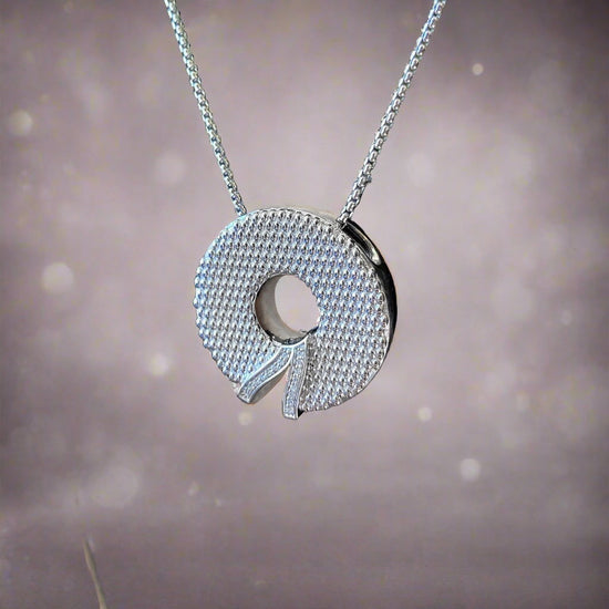 Photo of "Wreath" Pendant in a decorative scene, designed by , available at Plumb Gold & Plumb Silver