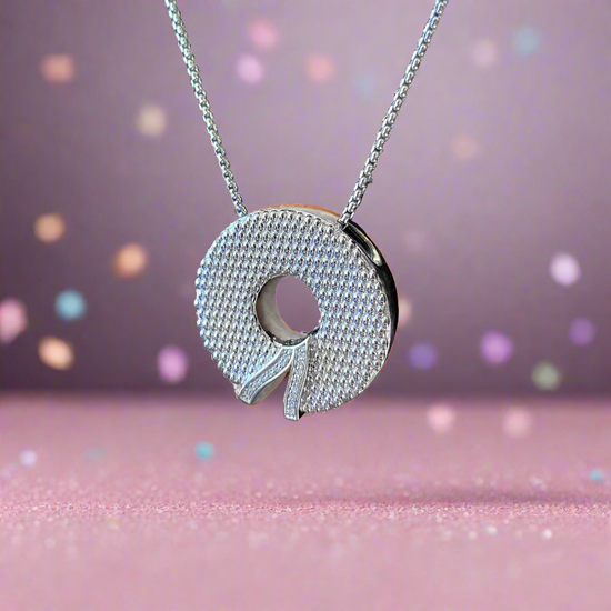 Photo of "Wreath" Pendant in a decorative scene, designed by , available at Plumb Gold & Plumb Silver