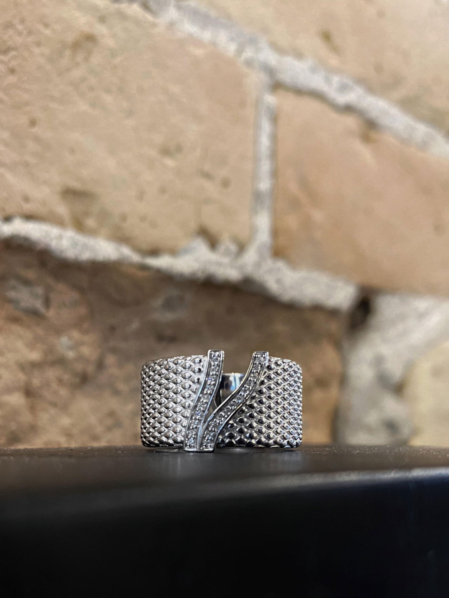 Photo of "Wreath" Ring in a decorative scene, designed by , available at Plumb Gold & Plumb Silver