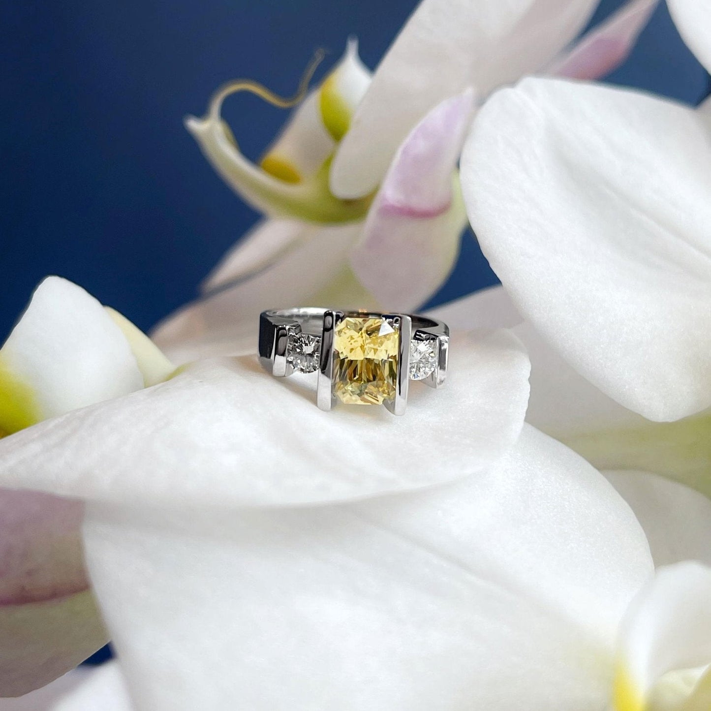 Photo of Yellow Sapphire and Diamond Ring in a decorative scene, designed by , available at Plumb Gold & Plumb Silver