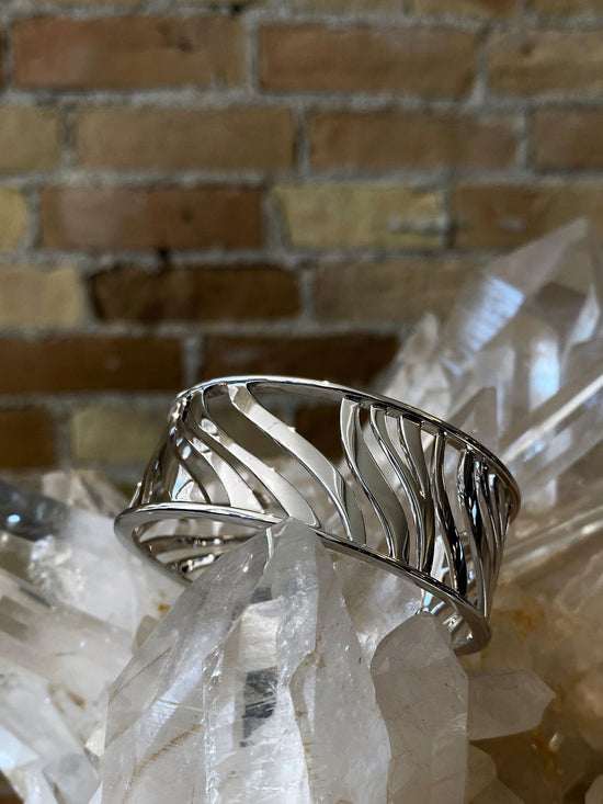 Photo of Zebra Stripe Cuff in a decorative scene, designed by , available at Plumb Gold & Plumb Silver