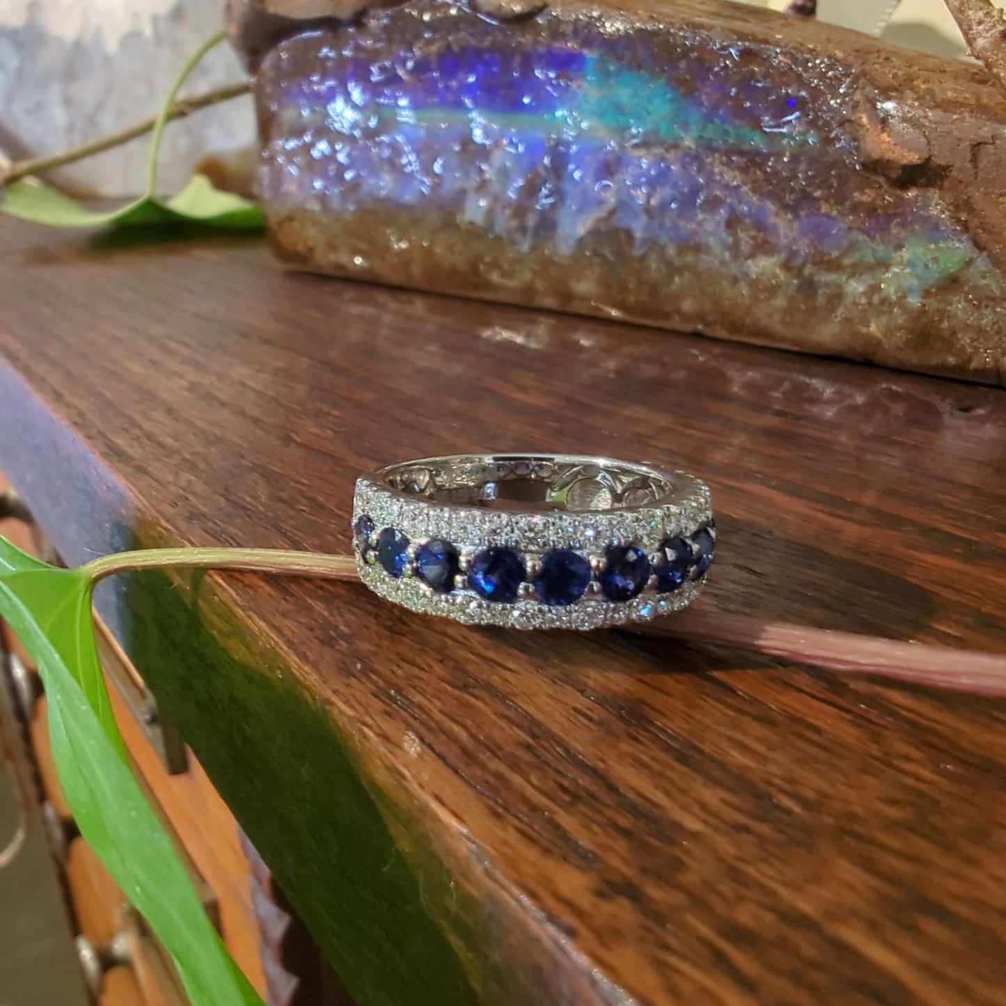 Photo of Zeghani Blue Sapphire and Diamond Ring in a decorative scene, designed by , available at Plumb Gold & Plumb Silver