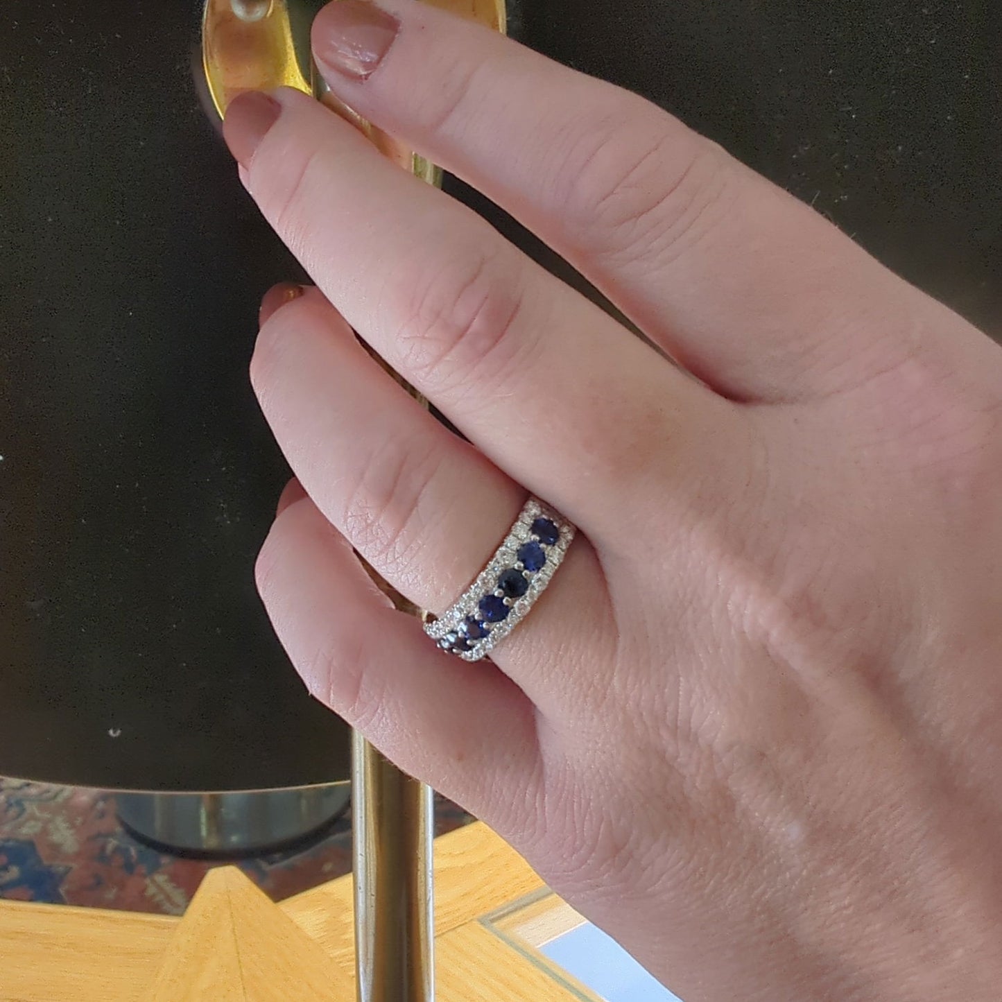 Photo of Zeghani Blue Sapphire and Diamond Ring in a decorative scene, designed by , available at Plumb Gold & Plumb Silver