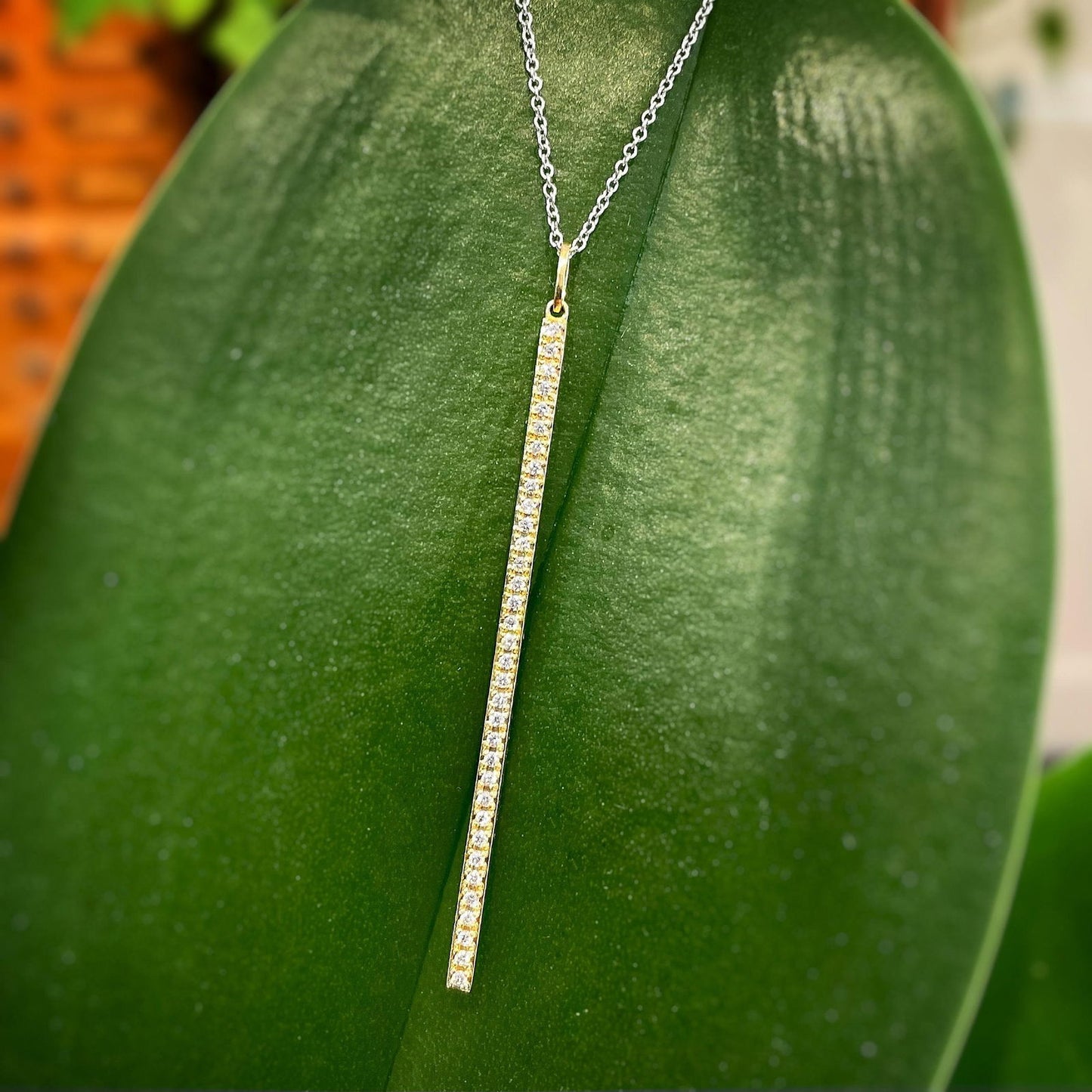 Photo of Zeghani Diamond Bar Necklace in a decorative scene, designed by , available at Plumb Gold & Plumb Silver