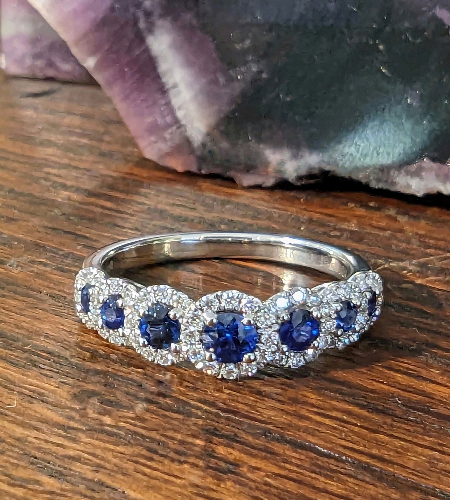 Photo of Zeghani Seven Halo Gemstone Ring in a decorative scene, designed by , available at Plumb Gold & Plumb Silver