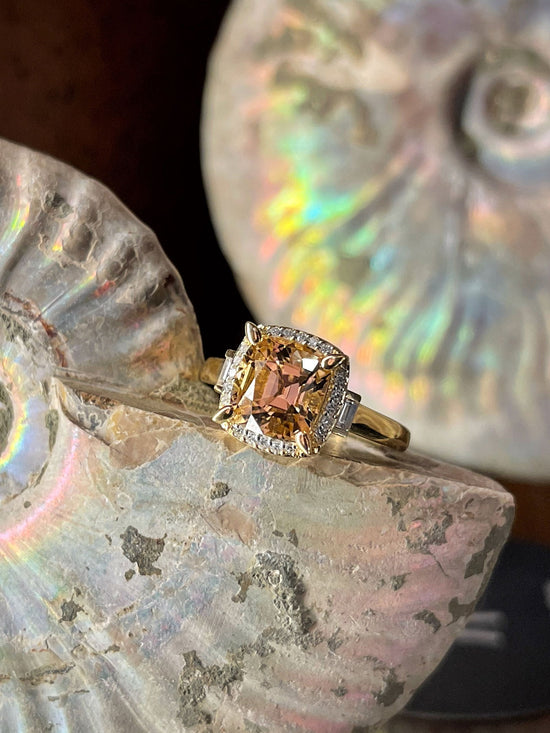 Photo of Zoma Color Peach Tourmaline Ring in a decorative scene, designed by , available at Plumb Gold & Plumb Silver