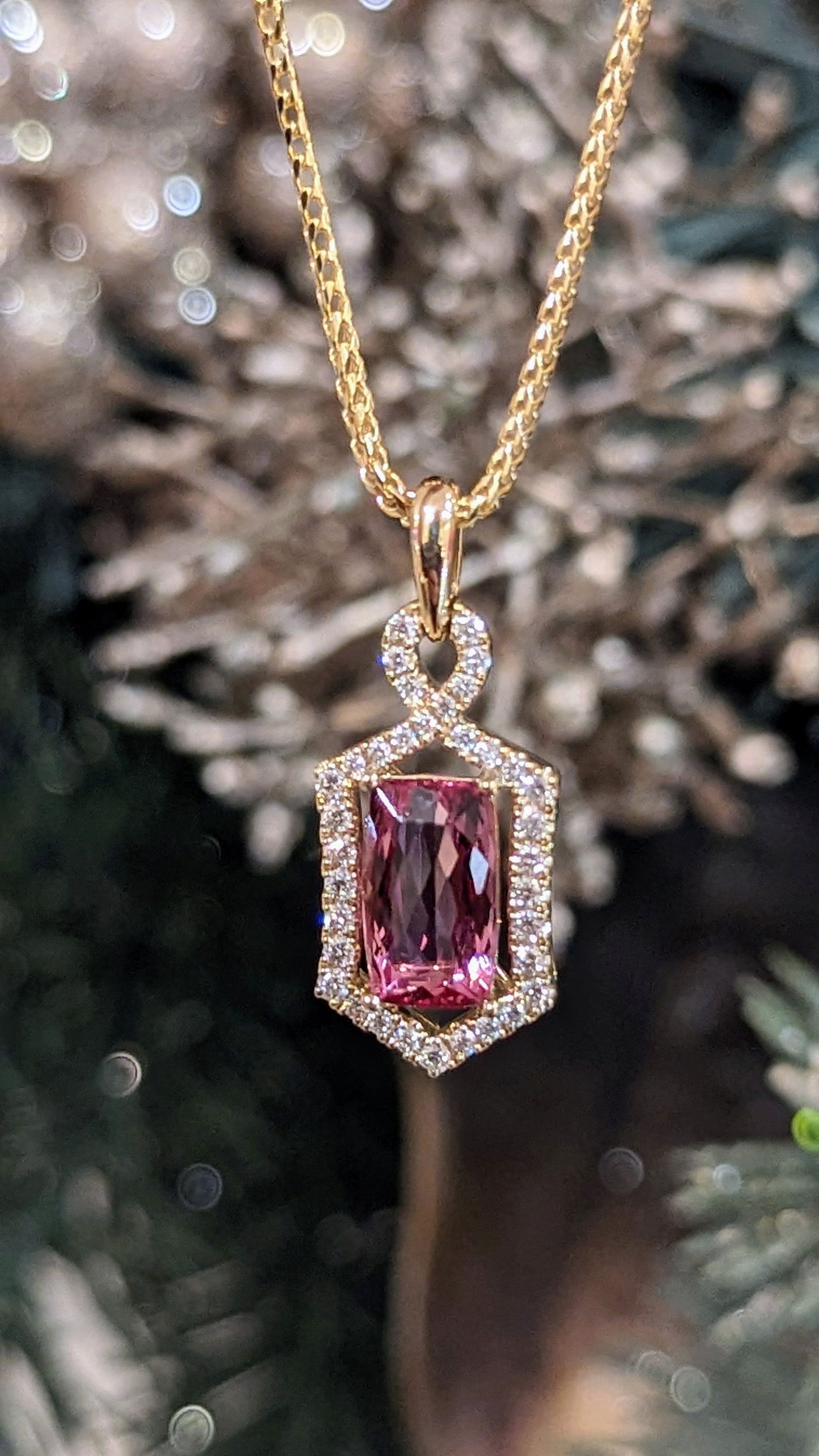Photo of Zoma Color Precious Topaz Pendant in a decorative scene, designed by , available at Plumb Gold & Plumb Silver