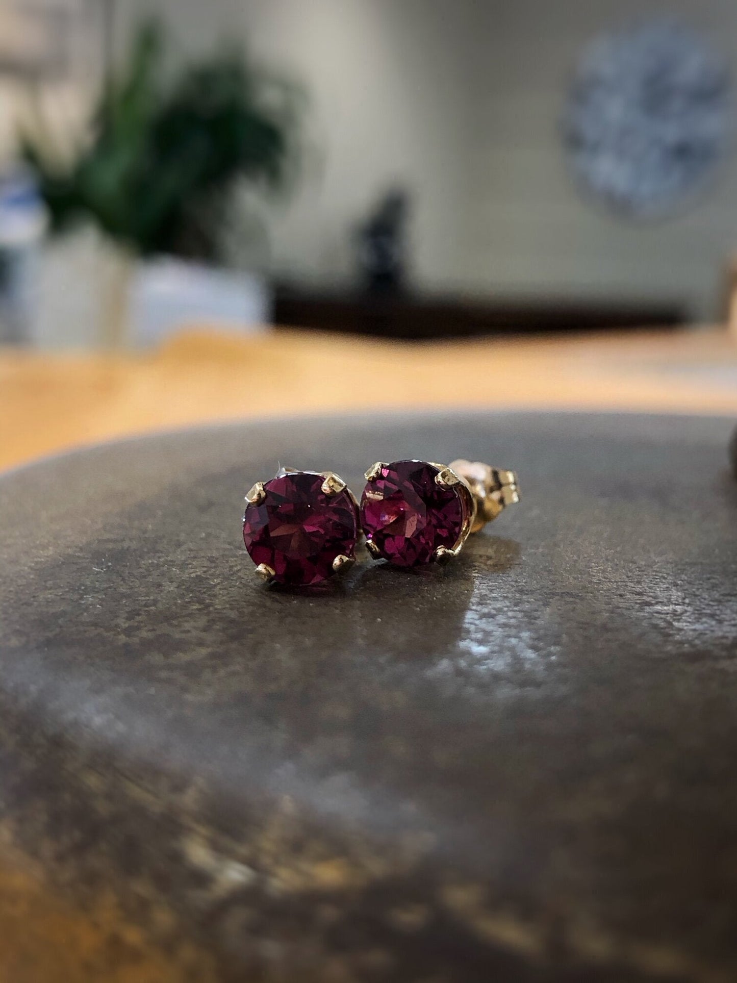 Photo of Zoma Color Rhodolite Garnet Studs in a decorative scene, designed by , available at Plumb Gold & Plumb Silver